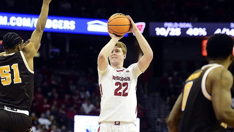 Dec 30, 2022; Madison, Wisconsin, USA; Wisconsin Badgers forward Steven Crowl (22) shoots a three-pointer against Western Michigan Broncos guard Jefferson Monegro (5) during the second half at the Kohl Center. Mandatory Credit: Kayla Wolf-USA TODAY Sports