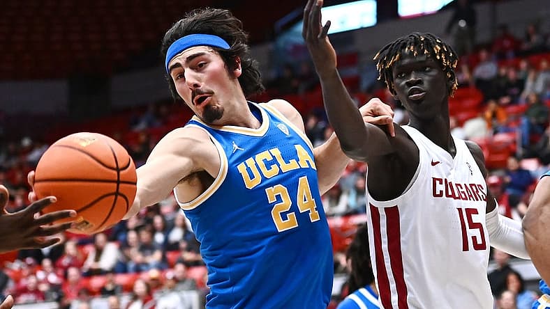 Dec 30, 2022; Pullman, Washington, USA; UCLA Bruins guard Jaime Jaquez Jr. (24) rebounds the ball against Washington State Cougars center Adrame Diongue (15) in the first half at Friel Court at Beasley Coliseum. Mandatory Credit: James Snook-USA TODAY Sports