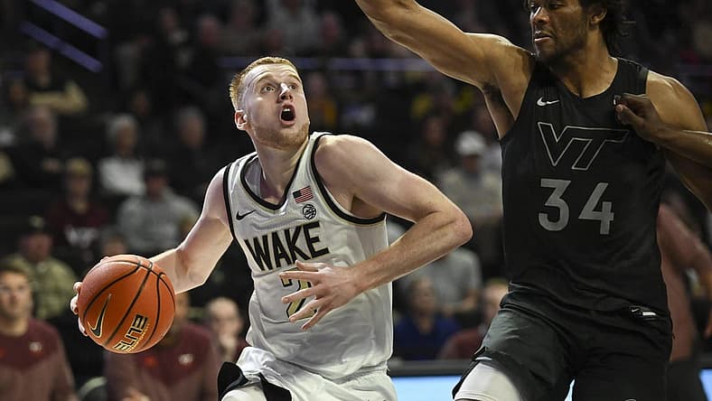 Dec 31, 2022; Winston-Salem, North Carolina, USA; Wake Forest Demon Deacons guard Cameron Hildreth (2) drives around Virginia Tech Hokies forward Mylyjael Poteat (34) during the first half at Lawrence Joel Veterans Memorial Coliseum. Mandatory Credit: William Howard-USA TODAY Sports