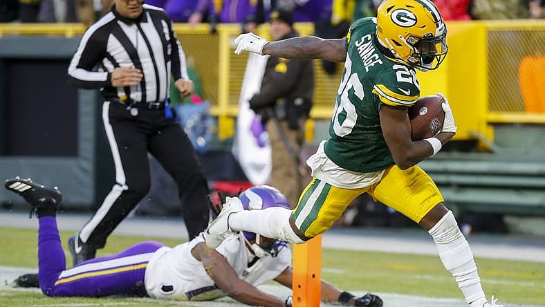 Jan 1, 2023; Green Bay, Wisconsin, USA; Green Bay Packers safety Darnell Savage (26) scores a touchdown on an interception return against the Minnesota Vikings at Lambeau Field. Mandatory Credit: Tork Mason-USA TODAY Sports