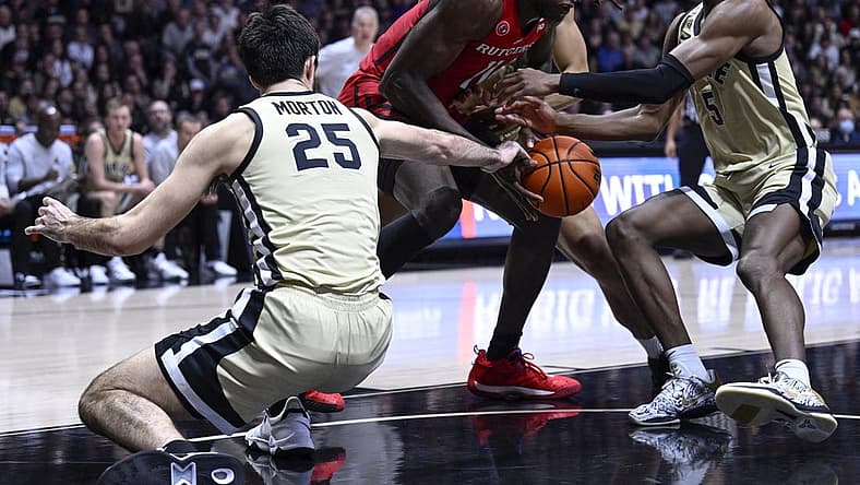 Jan 2, 2023; West Lafayette, Indiana, USA; Rutgers Scarlet Knights center Clifford Omoruyi (11) attempts to keep the ball away from multiple Purdue Boilermakers during the first half at Mackey Arena. Mandatory Credit: Marc Lebryk-USA TODAY Sports