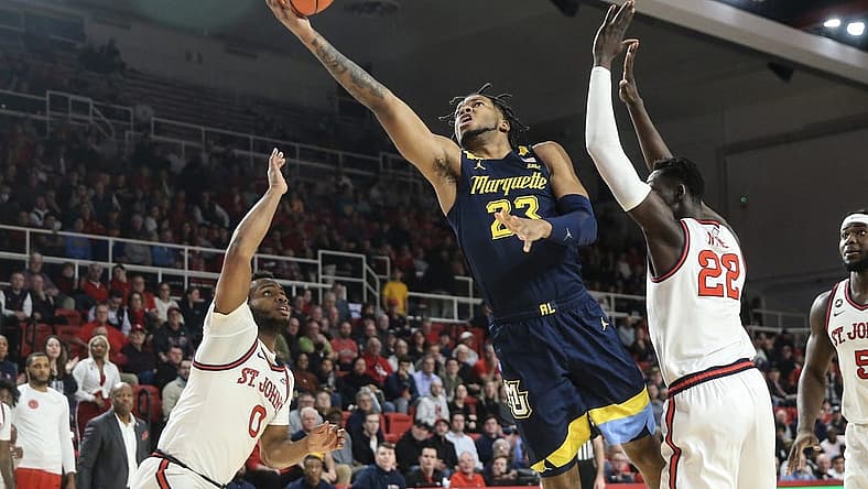 Jan 3, 2023; Queens, New York, USA; Marquette Golden Eagles forward David Joplin (23) drives past St. John's Red Storm forward Esahia Nyiwe (22) for a layup in the first half at Carnesecca Arena. Mandatory Credit: Wendell Cruz-USA TODAY Sports