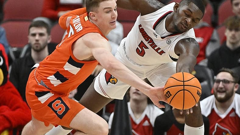 Jan 3, 2023; Louisville, Kentucky, USA; Syracuse Orange guard Justin Taylor (5) scrambles for a loose ball with Louisville Cardinals forward Brandon Huntley-Hatfield (5) during the first half at KFC Yum! Center. Mandatory Credit: Jamie Rhodes-USA TODAY Sports