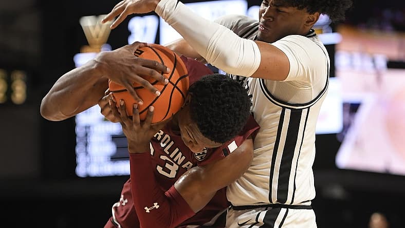 Jan 3, 2023; Nashville, Tennessee, USA; South Carolina Gamecocks forward Gregory Jackson II (23) and Vanderbilt Commodores guard Tyrin Lawrence (0) fight for the loose ball during the second half at Memorial Gymnasium. Mandatory Credit: Steve Roberts-USA TODAY Sports