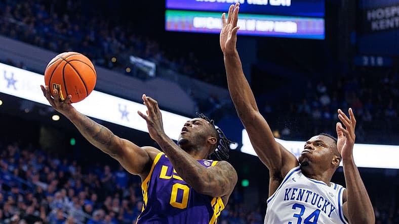 Jan 3, 2023; Lexington, Kentucky, USA; LSU Tigers guard Trae Hannibal (0) goes to the basket against Kentucky Wildcats forward Oscar Tshiebwe (34) during the first half at Rupp Arena at Central Bank Center. Mandatory Credit: Jordan Prather-USA TODAY Sports