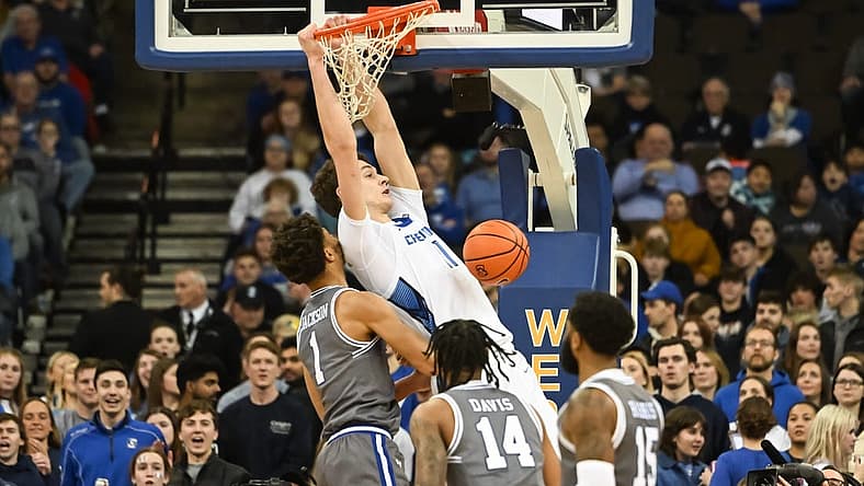 Jan 3, 2023; Omaha, Nebraska, USA; Creighton Bluejays center Ryan Kalkbrenner (11) dunks over Seton Hall Pirates forward Tray Jackson (1) in the first half at CHI Health Center Omaha. Mandatory Credit: Steven Branscombe-USA TODAY Sports