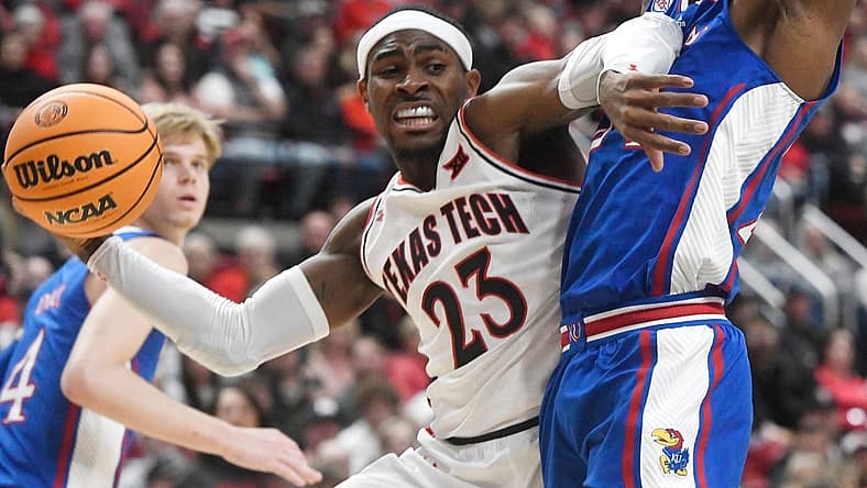 Texas Tech guard De'Vion Harmon (23), center, passes the ball against Kansas during the Big 12 basketball game, Tuesday, Jan. 3, 2023, at United Supermarkets Arena.