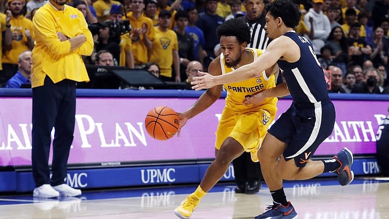 Jan 3, 2023; Pittsburgh, Pennsylvania, USA; Pittsburgh Panthers guard Nelly Cummings (0) drives to the basket against Virginia Cavaliers guard Kihei Clark (right) during the second half at the Petersen Events Center. Pittsburgh won 68-65. Mandatory Credit: Charles LeClaire-USA TODAY Sports