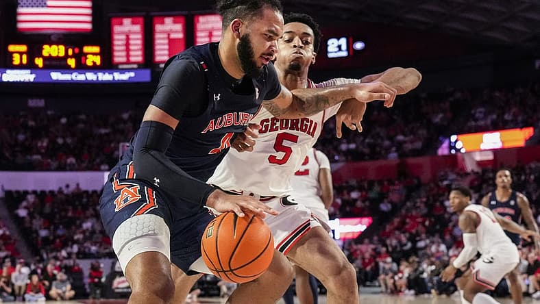Jan 4, 2023; Athens, Georgia, USA; Auburn Tigers forward Johni Broome (4) dribbles against Georgia Bulldogs center Frank Anselem (5) during the first half at Stegeman Coliseum. Mandatory Credit: Dale Zanine-USA TODAY Sports