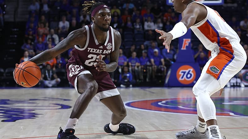 Jan 4, 2023; Gainesville, Florida, USA; Texas A&M Aggies guard Tyrece Radford (23) passes the ball as Florida Gators guard Kyle Lofton (11) defends during the first half at Exactech Arena at the Stephen C. O Connell Center. Mandatory Credit: Kim Klement-USA TODAY Sports