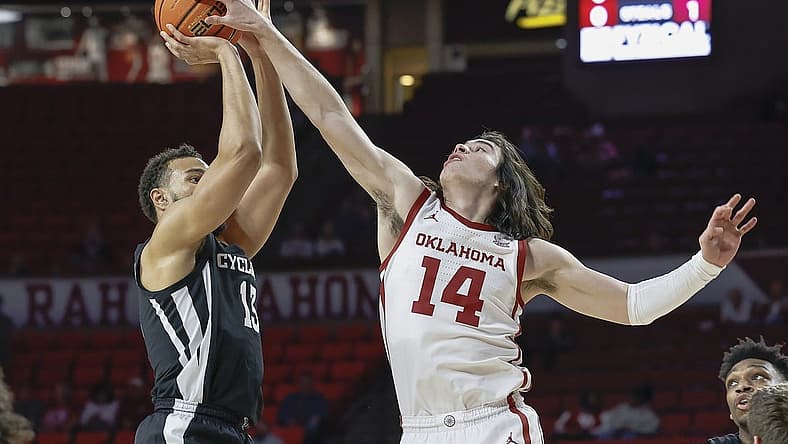 Jan 4, 2023; Norman, Oklahoma, USA; Oklahoma Sooners guard Bijan Cortes (14) blocks a shot by Iowa State Cyclones guard Jaren Holmes (13) during the first half at Lloyd Noble Center. Mandatory Credit: Alonzo Adams-USA TODAY Sports