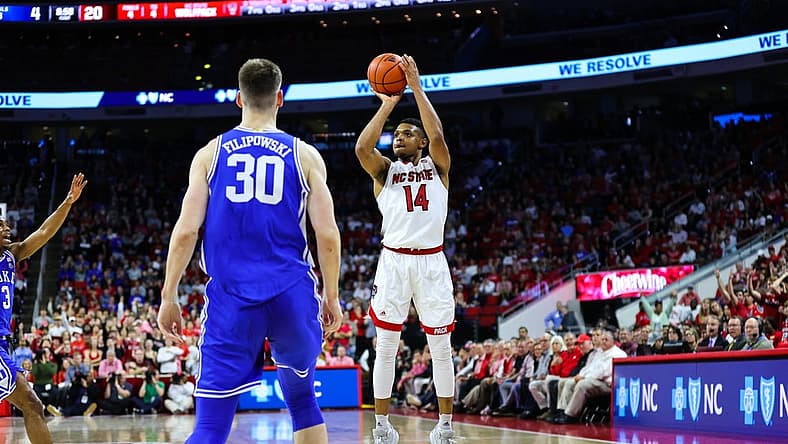 Jan 4, 2023; Raleigh, North Carolina, USA;  North Carolina State Wolfpack guard Casey Morsell (14) shoots a three pointer during the first half against Duke Blue Devils at at PNC Arena. Mandatory Credit: Jaylynn Nash-USA TODAY Sports