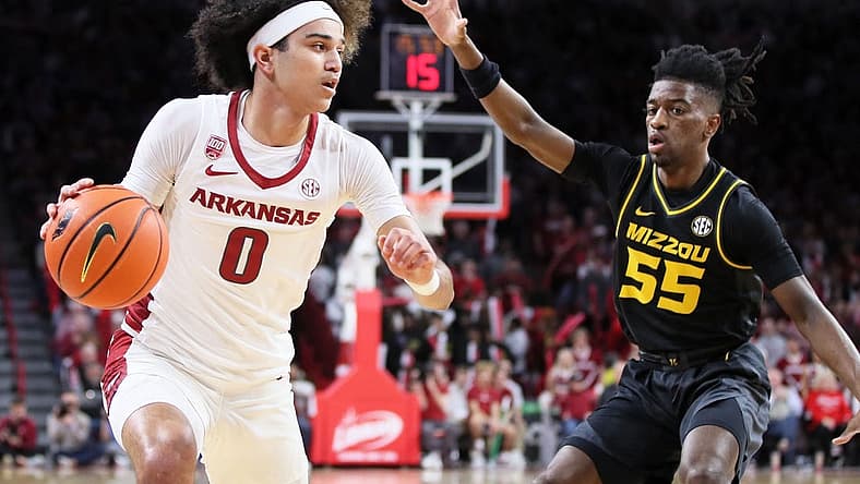 Jan 4, 2023; Fayetteville, Arkansas, USA; Arkansas Razorbacks guard Anthony Black (0) drives in the first half as Missouri Tigers guard Sean East II (55) defends at Bud Walton Arena. Mandatory Credit: Nelson Chenault-USA TODAY Sports