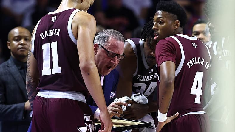 Jan 4, 2023; Gainesville, Florida, USA; Texas A&M Aggies head coach Buzz Williams talks with forward Andersson Garcia (11) and guard Wade Taylor IV (4) against the Florida Gators during the second half at Exactech Arena at the Stephen C. O'Connell Center. Mandatory Credit: Kim Klement-USA TODAY Sports