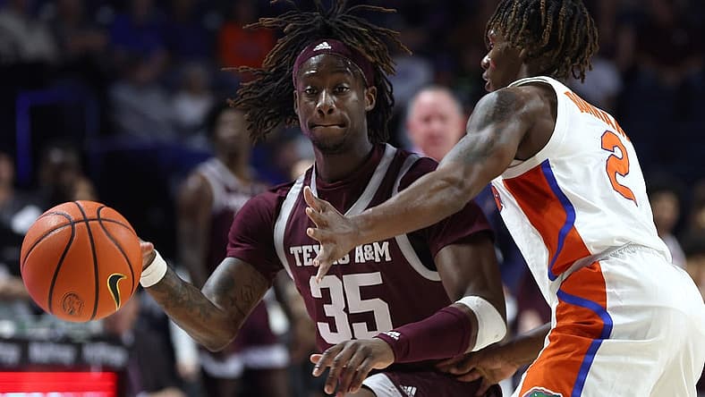 Jan 4, 2023; Gainesville, Florida, USA; Texas A&M Aggies guard Manny Obaseki (35) controls the ball while defended by Florida Gators guard Trey Bonham (2) during the first half at Exactech Arena at the Stephen C. O'Connell Center. Mandatory Credit: Kim Klement-USA TODAY Sports