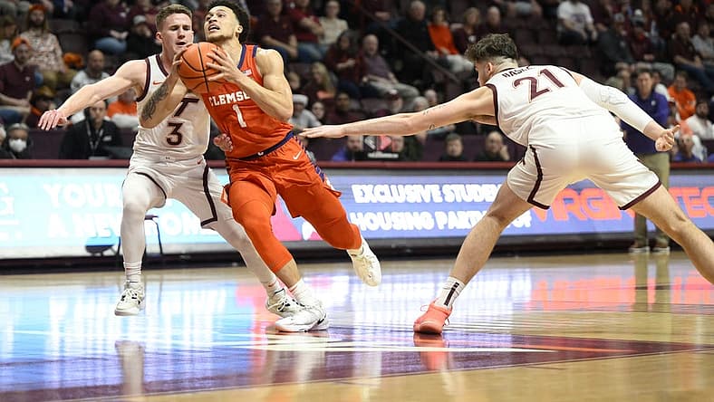 Jan 4, 2023; Blacksburg, Virginia, USA; Clemson Tigers guard Chase Hunter (1) drives to basket between Virginia Tech Hokies guard Sean Pedulla (3) and forward Grant Basile (21) in the first halfat Cassell Coliseum. Mandatory Credit: Lee Luther Jr.-USA TODAY Sports