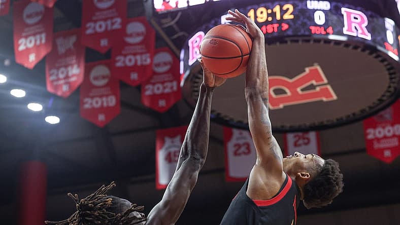Jan 5, 2023; Piscataway, New Jersey, USA; Rutgers Scarlet Knights center Clifford Omoruyi (11) blocks a shot by Maryland Terrapins guard Jahmir Young (1) during the first half at Jersey Mike's Arena. Mandatory Credit: Vincent Carchietta-USA TODAY Sports
