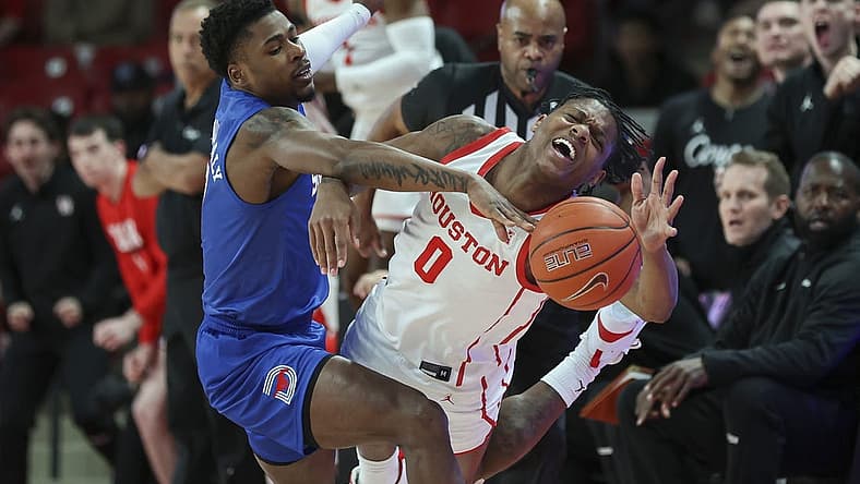 Jan 5, 2023; Houston, Texas, USA; Southern Methodist Mustangs guard Jefferson Koulibaly (0) and Houston Cougars guard Marcus Sasser (0) battle for the ball during the first half at Fertitta Center. Mandatory Credit: Troy Taormina-USA TODAY Sports