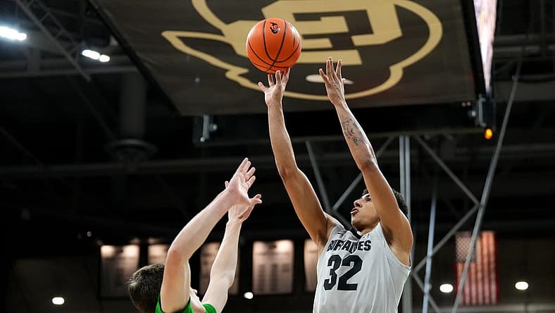 Jan 5, 2023; Boulder, Colorado, USA; Colorado Buffaloes guard Nique Clifford (32) shoots over Oregon Ducks guard Brennan Rigsby (4) in the first half at the CU Events Center. Mandatory Credit: Ron Chenoy-USA TODAY Sports