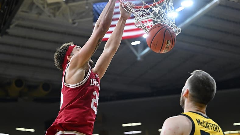 Jan 5, 2023; Iowa City, Iowa, USA; Indiana Hoosiers forward Race Thompson (25) completes a slam dunk over Iowa Hawkeyes guard Connor McCaffery (30) during the first half at Carver-Hawkeye Arena. Mandatory Credit: Jeffrey Becker-USA TODAY Sports