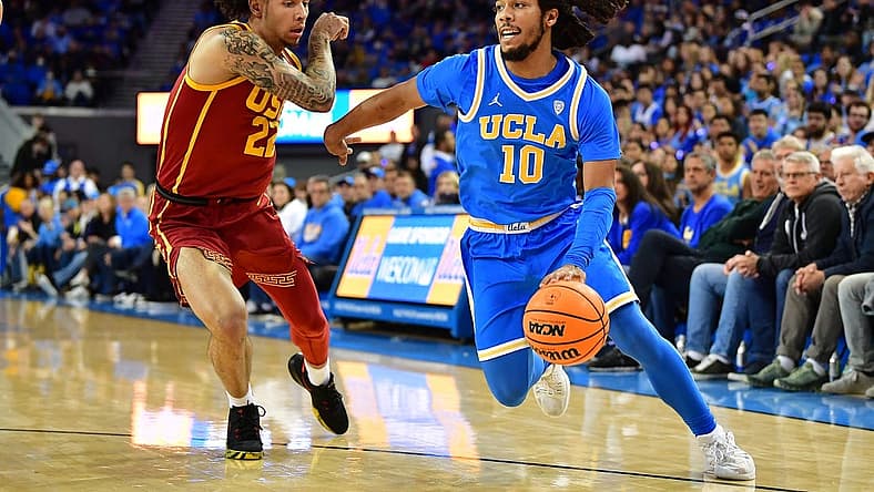 Jan 5, 2023; Los Angeles, California, USA; UCLA Bruins guard Tyger Campbell (10) moves the ball against Southern California Trojans guard Tre White (22) during the first half at Pauley Pavilion. Mandatory Credit: Gary A. Vasquez-USA TODAY Sports