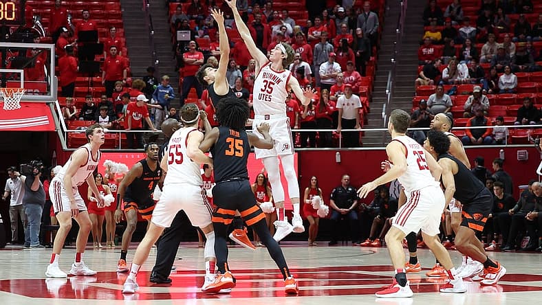 Jan 5, 2023; Salt Lake City, Utah, USA; Oregon State Beavers forward Dzmitry Ryuny (11) and Utah Utes center Branden Carlson (35) jump to tip of their game at Jon M. Huntsman Center. Mandatory Credit: Rob Gray-USA TODAY Sports