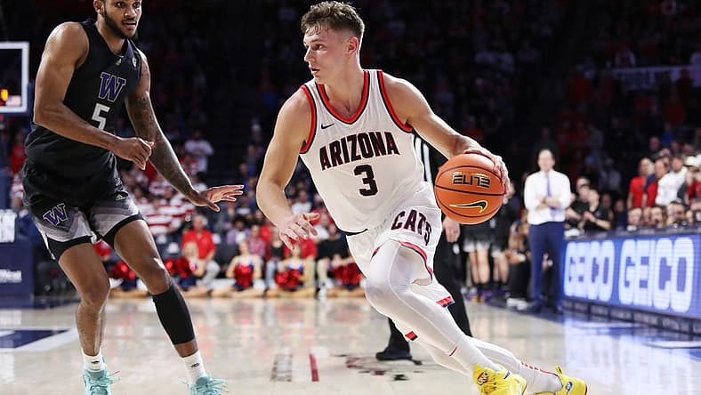 Jan 5, 2023; Tucson, Arizona, USA; Arizona Wildcats guard Pelle Larsson (3) drives to the net against Washington Huskies guard Jamal Bey (5) during the second half at McKale Center. Mandatory Credit: Zachary BonDurant-USA TODAY Sports