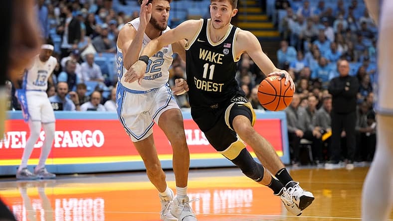 Jan 4, 2023; Chapel Hill, North Carolina, USA; Wake Forest Demon Deacons forward Andrew Carr (11) with the ball as North Carolina Tar Heels forward Pete Nance (32) defends in the first half at Dean E. Smith Center. Mandatory Credit: Bob Donnan-USA TODAY Sports