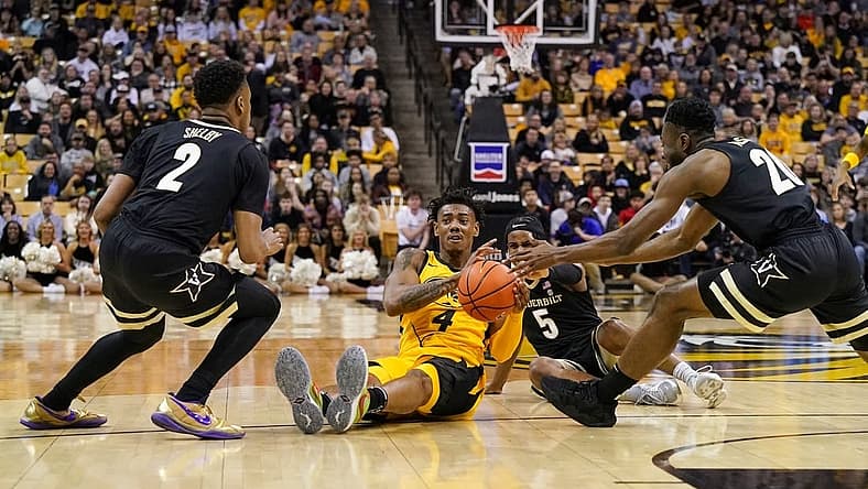 Jan 7, 2023; Columbia, Missouri, USA; Missouri Tigers guard DeAndre Gholston (4) and Vanderbilt Commodores guard Ezra Manjon (5) fight for a loose ball during the first half at Mizzou Arena. Mandatory Credit: Denny Medley-USA TODAY Sports