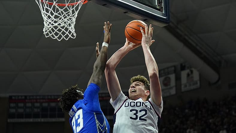 Jan 7, 2023; Storrs, Connecticut, USA; UConn Huskies center Donovan Clingan (32) shoots against Creighton Bluejays center Fredrick King (33) in the first half at Harry A. Gampel Pavilion. Mandatory Credit: David Butler II-USA TODAY Sports