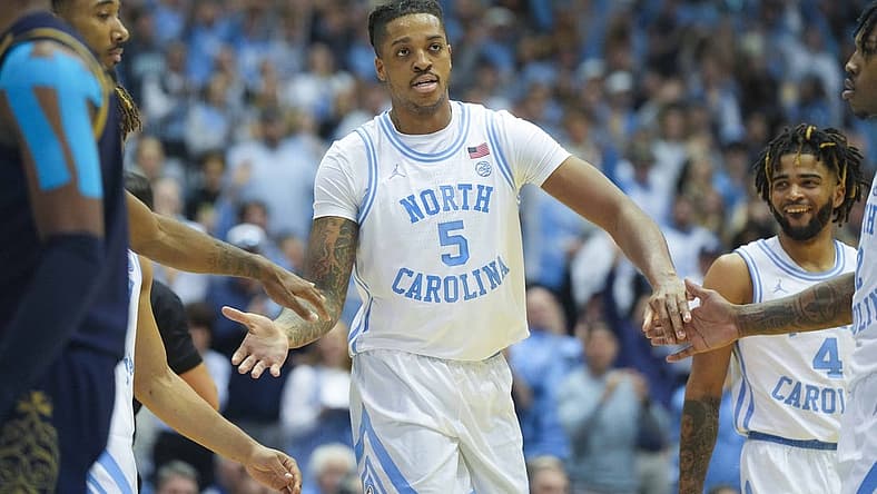 Jan 7, 2023; Chapel Hill, North Carolina, USA; North Carolina Tar Heels forward Armando Bacot (5) is congratulated by his teammates after his basket against the Notre Dame Fighting Irish during the second half at Dean E. Smith Center. Mandatory Credit: James Guillory-USA TODAY Sports
