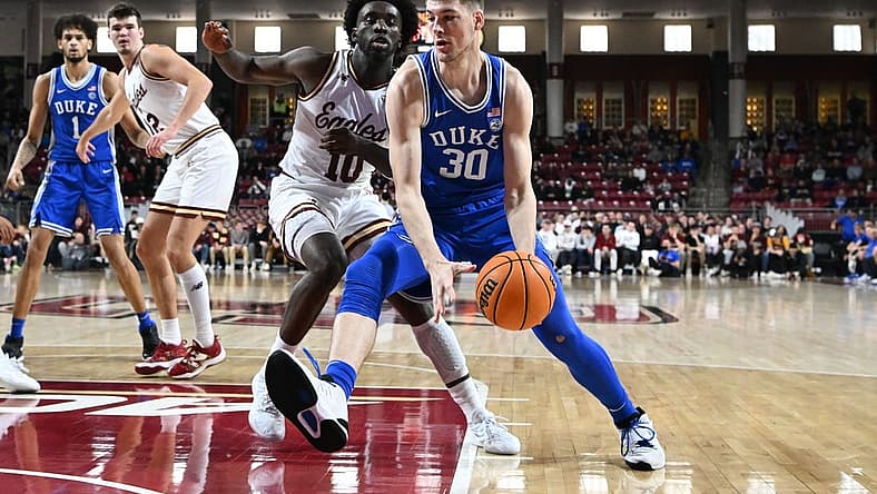 Jan 7, 2023; Chestnut Hill, Massachusetts, USA; Duke Blue Devils center Kyle Filipowski (30) drives to the basket against Boston College Eagles guard Prince Aligbe (10) during the first half at the Conte Forum. Mandatory Credit: Brian Fluharty-USA TODAY Sports