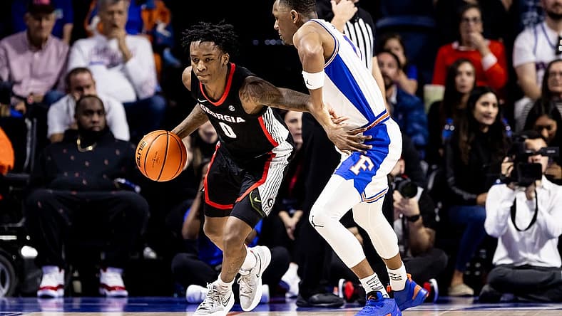 Jan 7, 2023; Gainesville, Florida, USA; Georgia Bulldogs guard Terry Roberts (0) dribbles the ball around Florida Gators guard Kyle Lofton (11) during the second half at Exactech Arena at the Stephen C. O'Connell Center. Mandatory Credit: Matt Pendleton-USA TODAY Sports