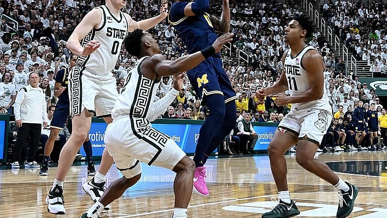 Jan 7, 2023; East Lansing, Michigan, USA; Michigan Wolverines guard Dug McDaniel (0) drives to the net against the Michigan State Spartans defense in the first half at Jack Breslin Student Events Center. Mandatory Credit: Dale Young-USA TODAY Sports