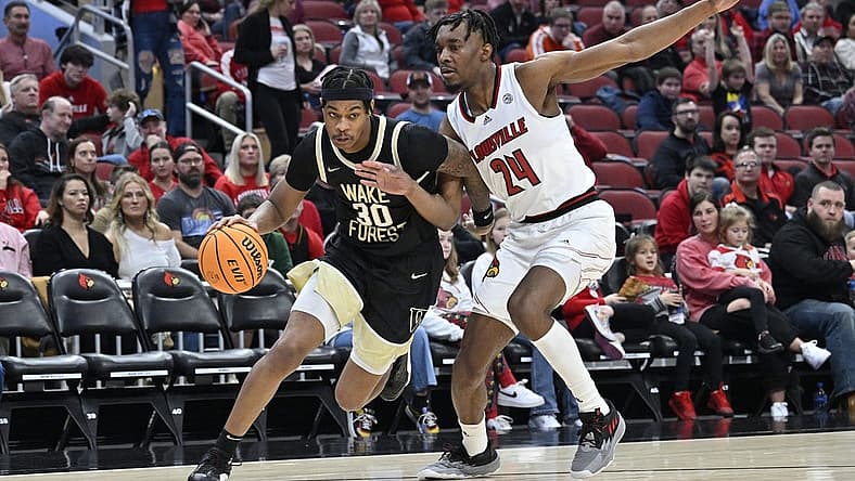 Jan 7, 2023; Louisville, Kentucky, USA; Wake Forest Demon Deacons guard Damari Monsanto (30) dribbles against Louisville Cardinals forward Jae'Lyn Withers (24) during the first half at KFC Yum! Center. Mandatory Credit: Jamie Rhodes-USA TODAY Sports