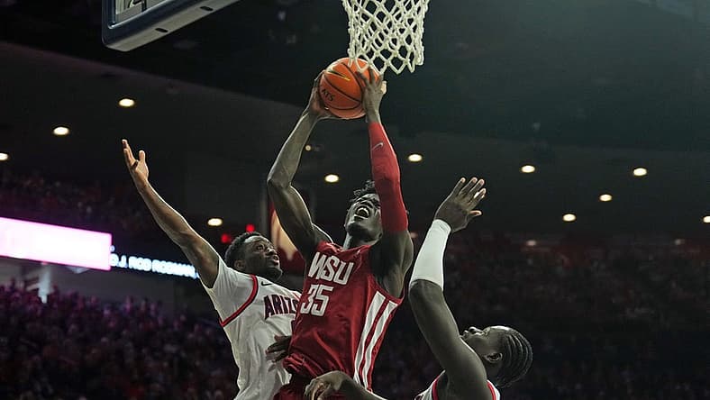 Jan 7, 2023; Tucson, Arizona, USA; Washington State Cougars forward Mouhamed Gueye (35) goes up for a layup against Arizona Wildcats guard Courtney Ramey (0) and Arizona Wildcats center Oumar Ballo (11) during the first half at McKale Center. Mandatory Credit: Joe Camporeale-USA TODAY Sports