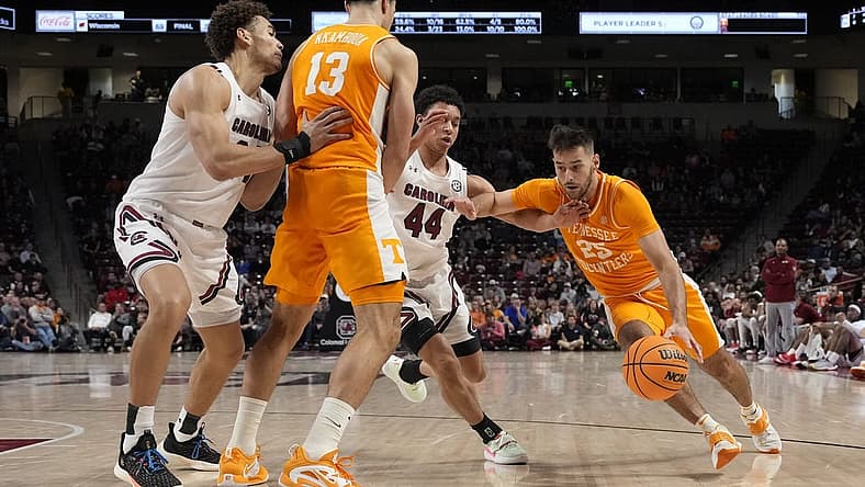 Jan 7, 2023; Columbia, South Carolina, USA; Tennessee Volunteers guard Santiago Vescovi (25) drives around a pic set by forward Olivier Nkamhoua (13) away from South Carolina Gamecocks guard Ford Cooper Jr. (44) during the second half at Colonial Life Arena. Mandatory Credit: Jim Dedmon-USA TODAY Sports