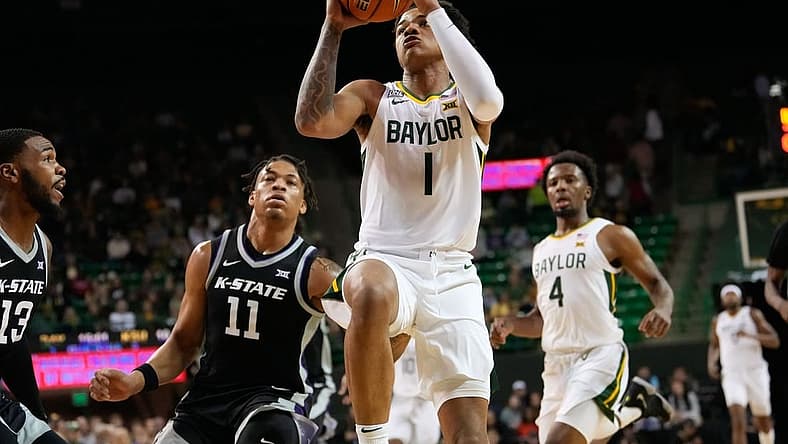 Jan 7, 2023; Waco, Texas, USA; Baylor Bears guard Keyonte George (1) scores a layup past Kansas State Wildcats forward Keyontae Johnson (11) during the first half at Ferrell Center. Mandatory Credit: Chris Jones-USA TODAY Sports