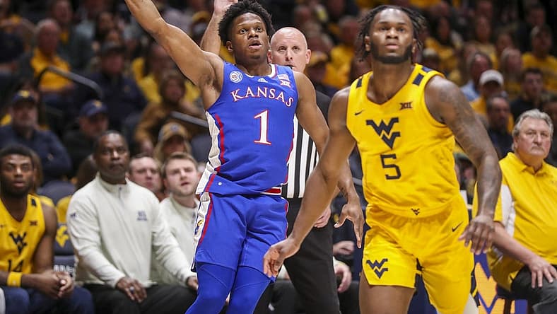 Jan 7, 2023; Morgantown, West Virginia, USA; Kansas Jayhawks guard Joseph Yesufu (1) shoots a three point basket over West Virginia Mountaineers guard Joe Toussaint (5) during the first half at WVU Coliseum. Mandatory Credit: Ben Queen-USA TODAY Sports