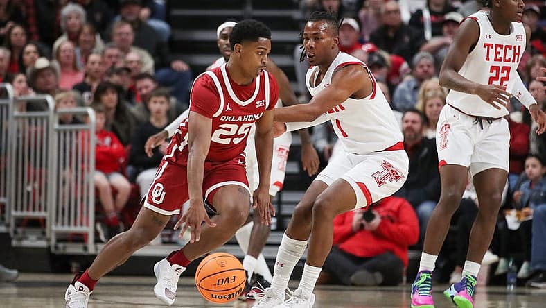 Jan 7, 2023; Lubbock, Texas, USA; Oklahoma Sooners guard Brant Sherfield (25) dribbles the ball against Texas Tech Red Raiders guard Lamar Washington (1) in the first half at United Supermarkets Arena. Mandatory Credit: Michael C. Johnson-USA TODAY Sports