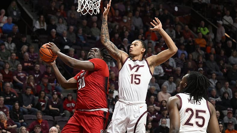 Jan 7, 2023; Blacksburg, Virginia, USA; North Carolina State Wolfpack forward D.J. Burns Jr. (30) drives to basket against Virginia Tech Hokies center Lynn Kidd (15) in the first half at Cassell Coliseum. Mandatory Credit: Lee Luther Jr.-USA TODAY Sports