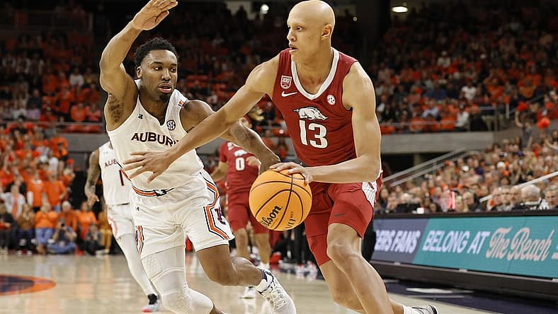 Jan 7, 2023; Auburn, Alabama, USA; Arkansas Razorbacks guard Jordan Walsh (13) drives against Auburn Tigers forward Chris Moore (5) during the first half at Neville Arena. Mandatory Credit: John Reed-USA TODAY Sports