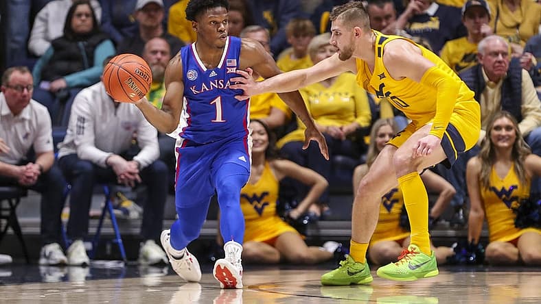 Jan 7, 2023; Morgantown, West Virginia, USA; Kansas Jayhawks guard Joseph Yesufu (1) passes the ball while being defended by West Virginia Mountaineers guard Erik Stevenson (10) during the second half at WVU Coliseum. Mandatory Credit: Ben Queen-USA TODAY Sports