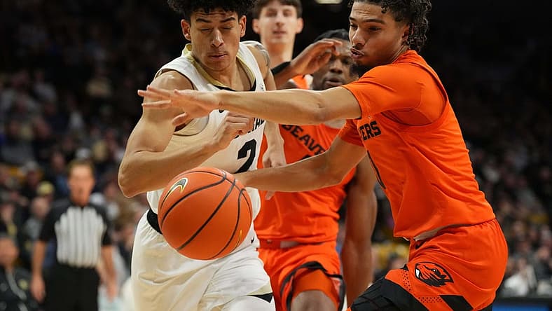 Jan 7, 2023; Boulder, Colorado, USA; Oregon State Beavers guard Jordan Pope (0) knocks the ball away from Colorado Buffaloes guard KJ Simpson (2) in the first half at CU Events Center. Mandatory Credit: Ron Chenoy-USA TODAY Sports