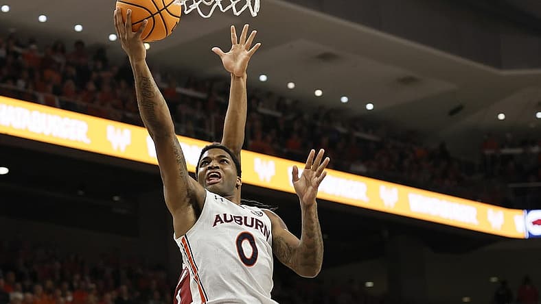Jan 7, 2023; Auburn, Alabama, USA; Auburn Tigers guard K.D. Johnson (0) drives for a layup against the Arkansas Razorbacks during the second half at Neville Arena. Mandatory Credit: John Reed-USA TODAY Sports