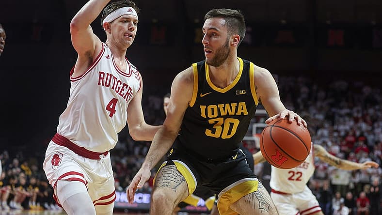 Jan 8, 2023; Piscataway, New Jersey, USA; Iowa Hawkeyes guard Connor McCaffery (30) dribbles against Rutgers Scarlet Knights guard Paul Mulcahy (4) during the first half at Jersey Mike's Arena. Mandatory Credit: Vincent Carchietta-USA TODAY Sports