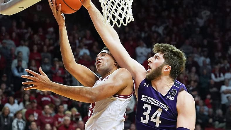 Jan 8, 2023; Bloomington, Indiana, USA; Northwestern Wildcats center Matthew Nicholson (34) blocks the shot attempt from Indiana Hoosiers forward Trayce Jackson-Davis (23) during the first half at Simon Skjodt Assembly Hall. Mandatory Credit: Robert Goddin-USA TODAY Sports