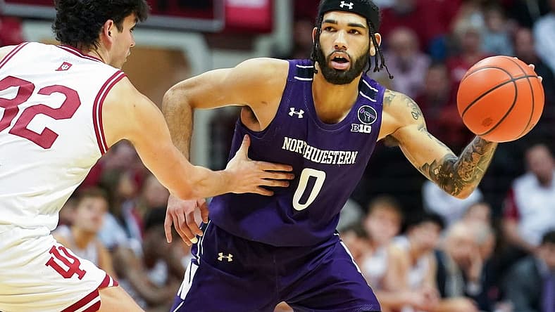 Jan 8, 2023; Bloomington, Indiana, USA;  Northwestern Wildcats guard Boo Buie (0) passes the ball around Indiana Hoosiers guard Trey Galloway (32) during the second half at Simon Skjodt Assembly Hall. Mandatory Credit: Robert Goddin-USA TODAY Sports