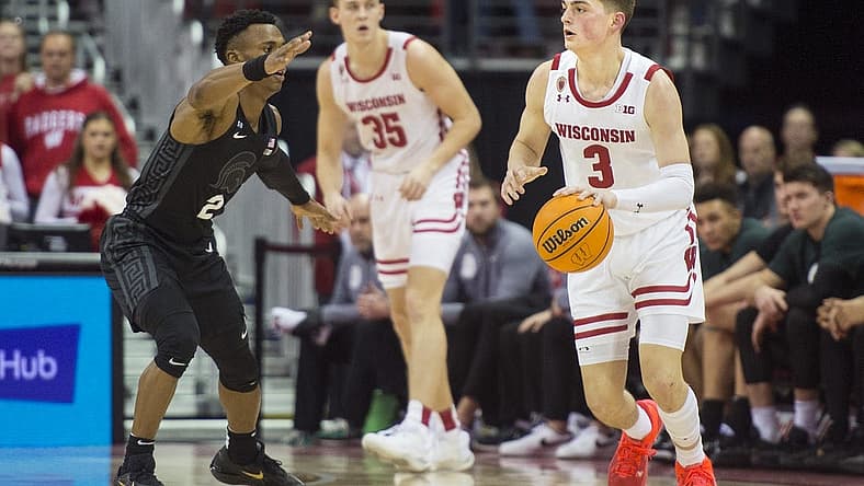 Jan 10, 2023; Madison, Wisconsin, USA;  Wisconsin Badgers guard Connor Essegian (3) dribbles the ball against Michigan State Spartans guard Tyson Walker (2) during the first half at the Kohl Center. Mandatory Credit: Kayla Wolf-USA TODAY Sports