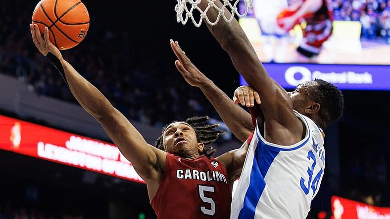 Jan 10, 2023; Lexington, Kentucky, USA; South Carolina Gamecocks guard Meechie Johnson (5) goes to the basket against Kentucky Wildcats forward Oscar Tshiebwe (34) during the first half at Rupp Arena at Central Bank Center. Mandatory Credit: Jordan Prather-USA TODAY Sports